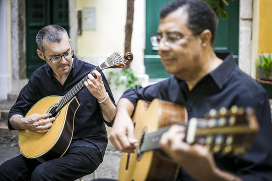 Two fado guitarists with acoustic and portuguese guitars