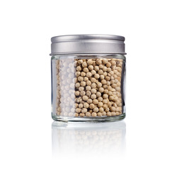 white pepper in a glas with metal lid, isolated on white