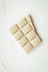 White and milk chocolate. Tiles of chocolate on a white background