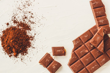 Coffee,white and milk chocolate. Tiles of chocolate on a white background.