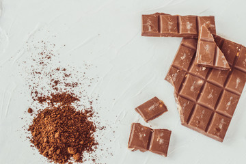 Coffee,white and milk chocolate. Tiles of chocolate on a white background.