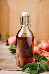 Apple vinegar on wooden table with apples. Country style.