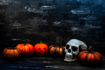 Halloween concept with a pumpkin and skeleton on background