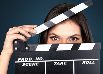 Young woman with movie clapper isolated