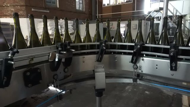 Bottling and sealing conveyor line at winery factory