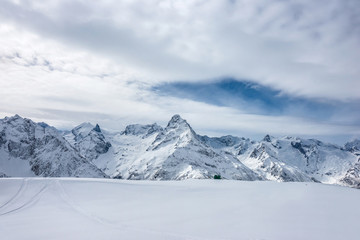 Plakat Snow covered Mt. Belalakaya at winter cloudy day. View from Mt. Mussa-Achitara slope, Karachai-Cherkess, Russia.