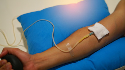 close up on patient hand with syringe cable ,doctor and patient concept