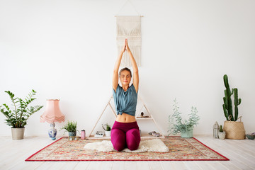 mindfulness, spirituality and healthy lifestyle concept - woman meditating at yoga studio - obrazy, fototapety, plakaty