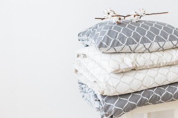 Two bedding sets in grey and beige, cool for two children, for siblings. Modern bed linen, in trend, minimalism clean home concept