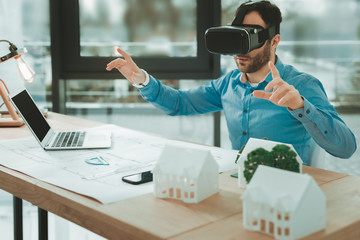 Virtual reality. Nice pleasant man using 3d glasses while working in the office