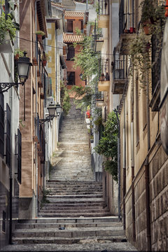 Naklejka Old street with stairs in Granada in Spain.