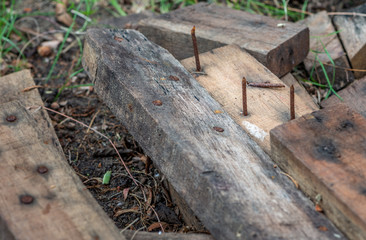 Dengerous rusty nail on wood board plank.