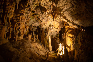 View of stalactites and stalagmites in an underground cavern - Postojna cave in Slovenia