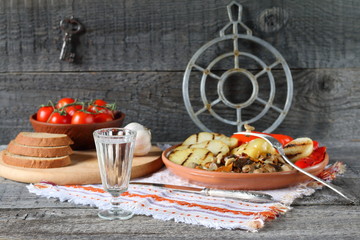 A glass of vodka on the dining table.