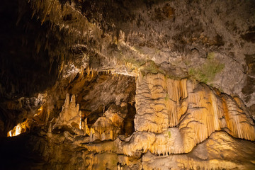 View of stalactites and stalagmites in an underground cavern - Postojna cave in Slovenia