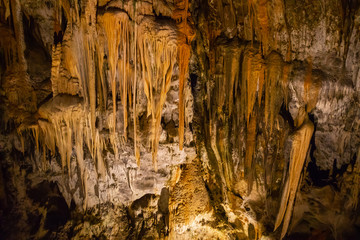 View of stalactites and stalagmites in an underground cavern - Postojna cave in Slovenia