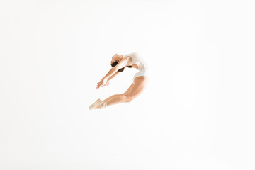 Ballet Dancer Performing High Jump And Backbend On White Background