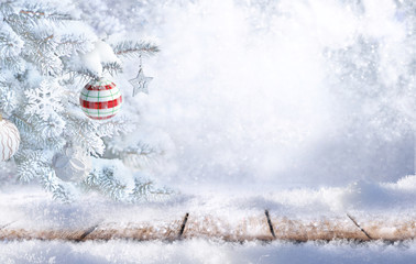 Winter christmas scenic  landscape background with copy space. Wooden flooring covered with snow in forest and Christmas tree on nature is decorated with toys.