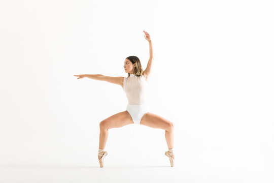 Energetic Female Dancer Performing Ballet Squat
