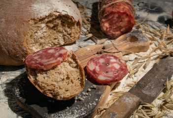 Still life is bread with salami. On the background of the fire