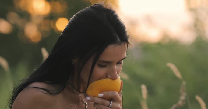 Crazy woman eating grapefruit on nature
