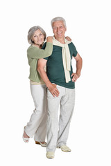 portrait of senior couple embracing on white background
