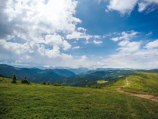Fototapeta na wymiar The summer green Carpathian mountains in Ukraine. The sky is over the mountains. Atmospheric landscapes while traveling on a jeep. Offroad expedition
