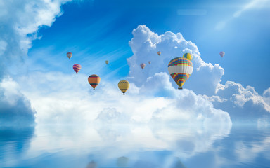 Hot air balloons fly in blue sky