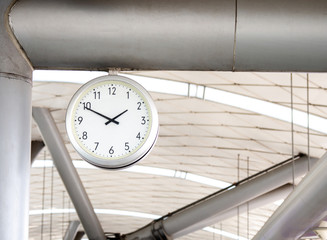 The big wall clock in the subway for passenger looking the time at subway platform.