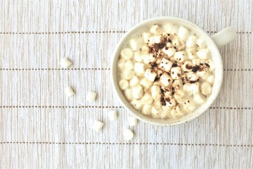 Cup of hot chocolate with marshmallows, top view, copy space.