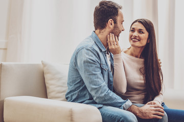 Happy family. Delighted positive woman touching her husbands face while expressing her feelings