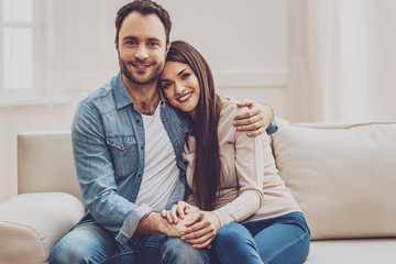 Happy marriage. Joyful positive man hugging his wife while being happy in the relationships