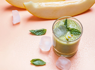 Delicious melon and basil smoothie on the bright background
