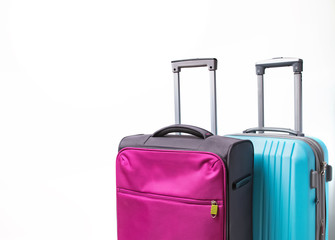 Two suitcases of pink and blue color close-up.
