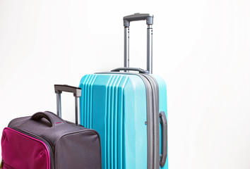 Two suitcases of pink and blue color close-up.