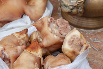 pig heads offered to the gods at thailand