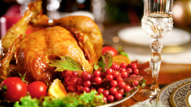 Closeup image of roasted chciken with cranberries on big festive dish
