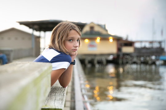 Child Tween Girl on Pier Looking out to Sea Pondering Future