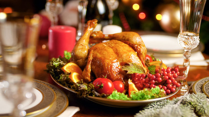 Fototapeta na wymiar Closeup image of served Christmas dinner table with tasty roasted chicken on big dish
