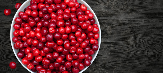 Appetizing Red Cherries Bowl on Black Background