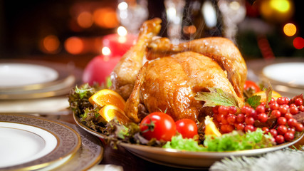 Fototapeta na wymiar Hot freshly roasted chicken on festive Christmas dining table