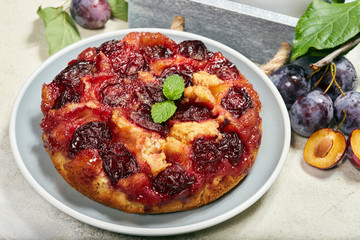 Delicious sponge cake with caramelized plums. Sweet autumn dessert