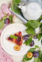 Delicious sponge cake with caramelized plums. Sweet autumn dessert