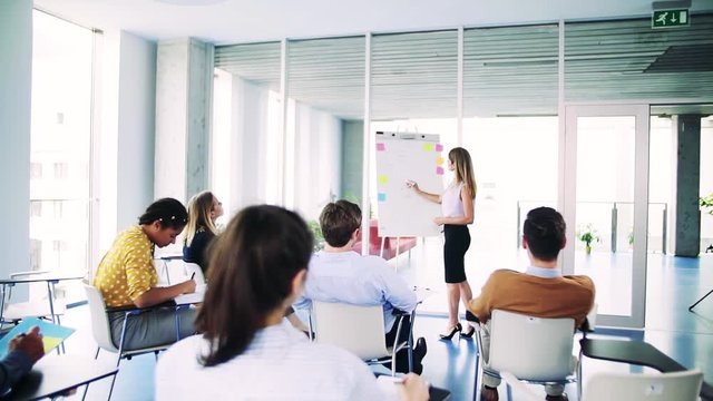 A group of businesspeople sitting in a board room, brainstorming.