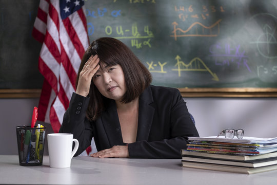 Portrait Of A Stressed Teacher In Her Classroom