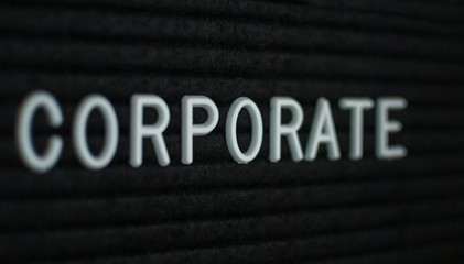 Word corporate written on the letter board. White letters on the black background