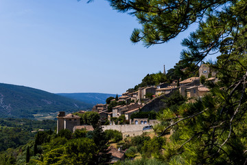Fototapeta na wymiar beautiful green trees, traditional houses and scenic mountains in provence, france