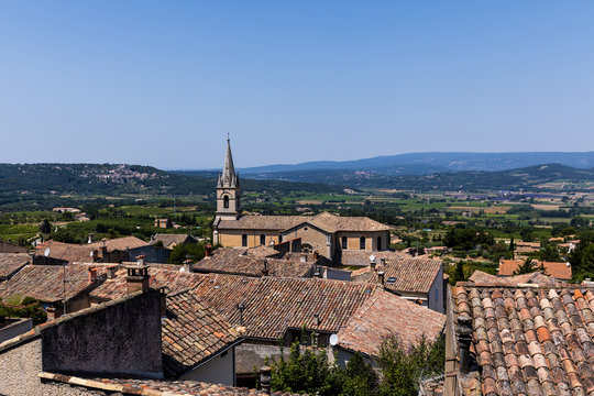 beautiful traditional architecture, rooftops and distant mountains in Bonnieux, France