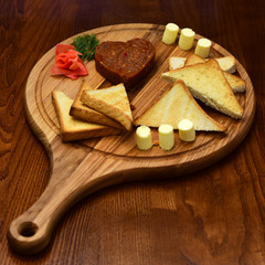 White toasted bread slices on wooden cutting board. Bread and butter. It is always fresh