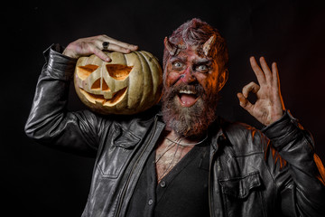 Halloween devil with bloody horns show ok hand gesture